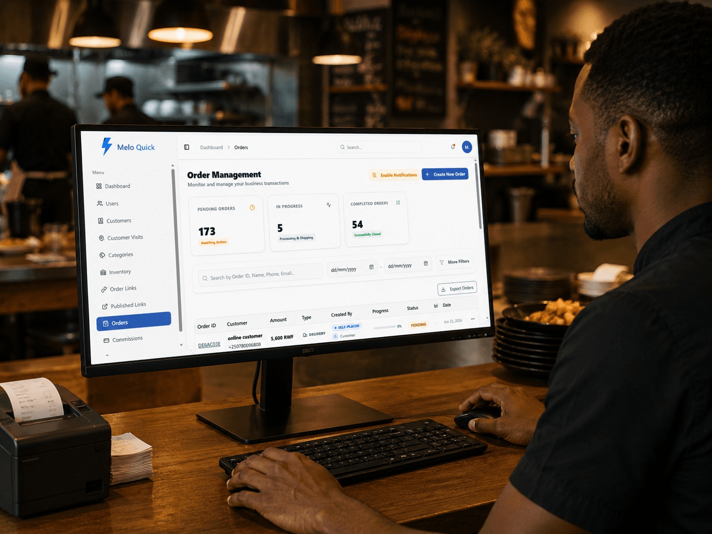 Person managing orders on a laptop